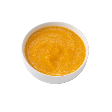 Vibrant creamy orange puree in a white bowl, perfect for dips or sauces.