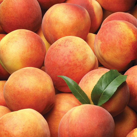 Vibrant fresh peaches in a basket, showcasing ripe colors and natural leaves.