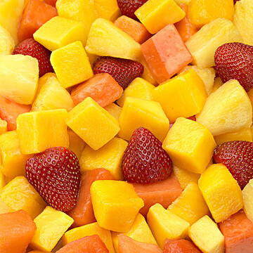 Vibrant fruit mosaic salad with fresh mango, pineapple, strawberries, and papaya for a healthy treat.