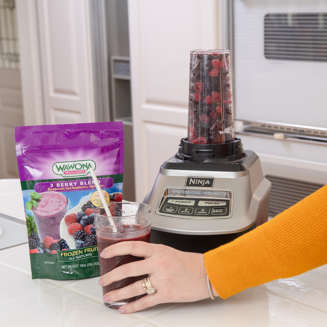 Ninja blender and Wawona frozen fruit create a delicious berry smoothie in a modern kitchen.