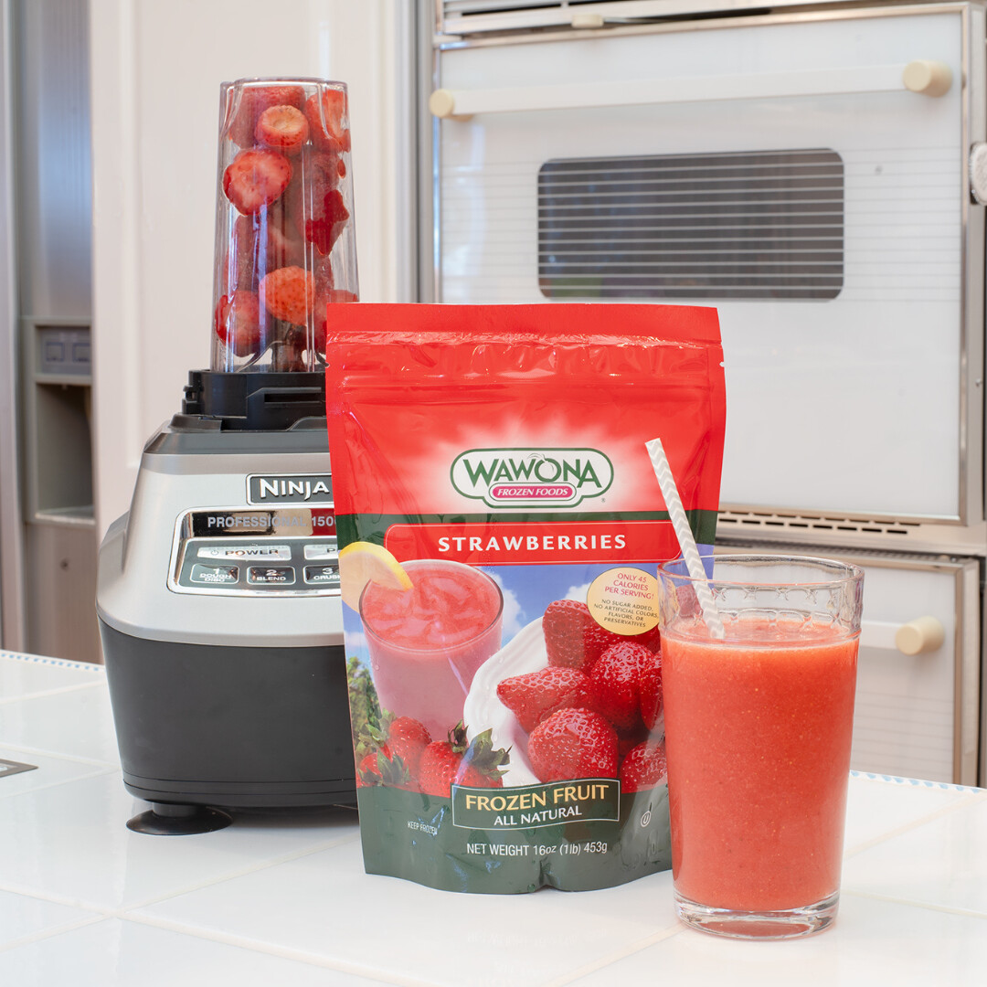 Refreshing strawberry smoothie prepared with Wawona frozen strawberries in a modern kitchen.