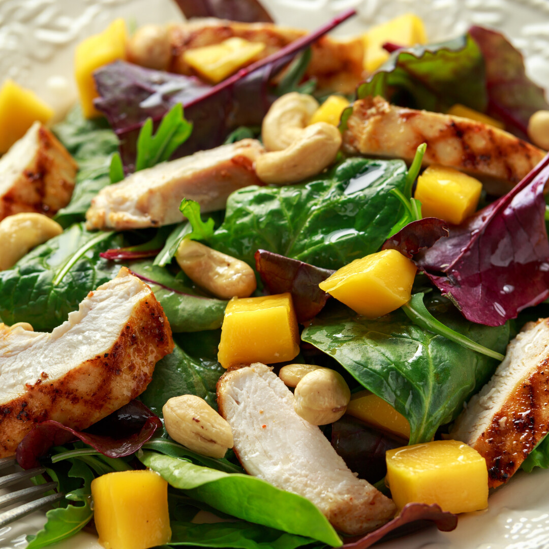 Vibrant chicken mango salad with fresh greens, juicy mango, and crunchy cashews.