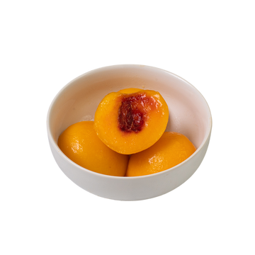 Ripe yellow peaches in an elegant white bowl, showcasing freshness and culinary beauty.